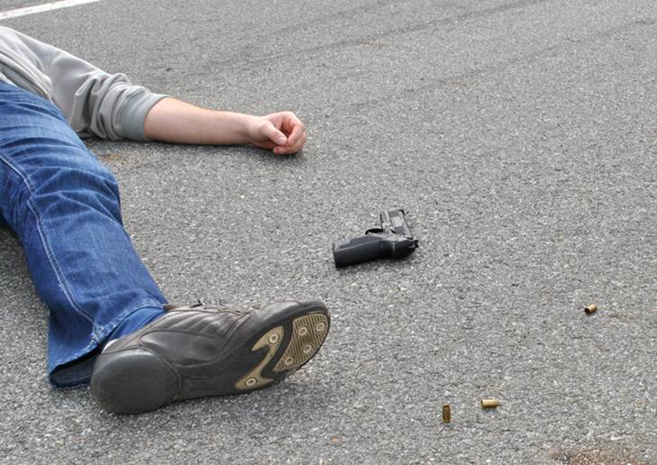 A person lying on the ground next to an object

AI-generated content may be incorrect.